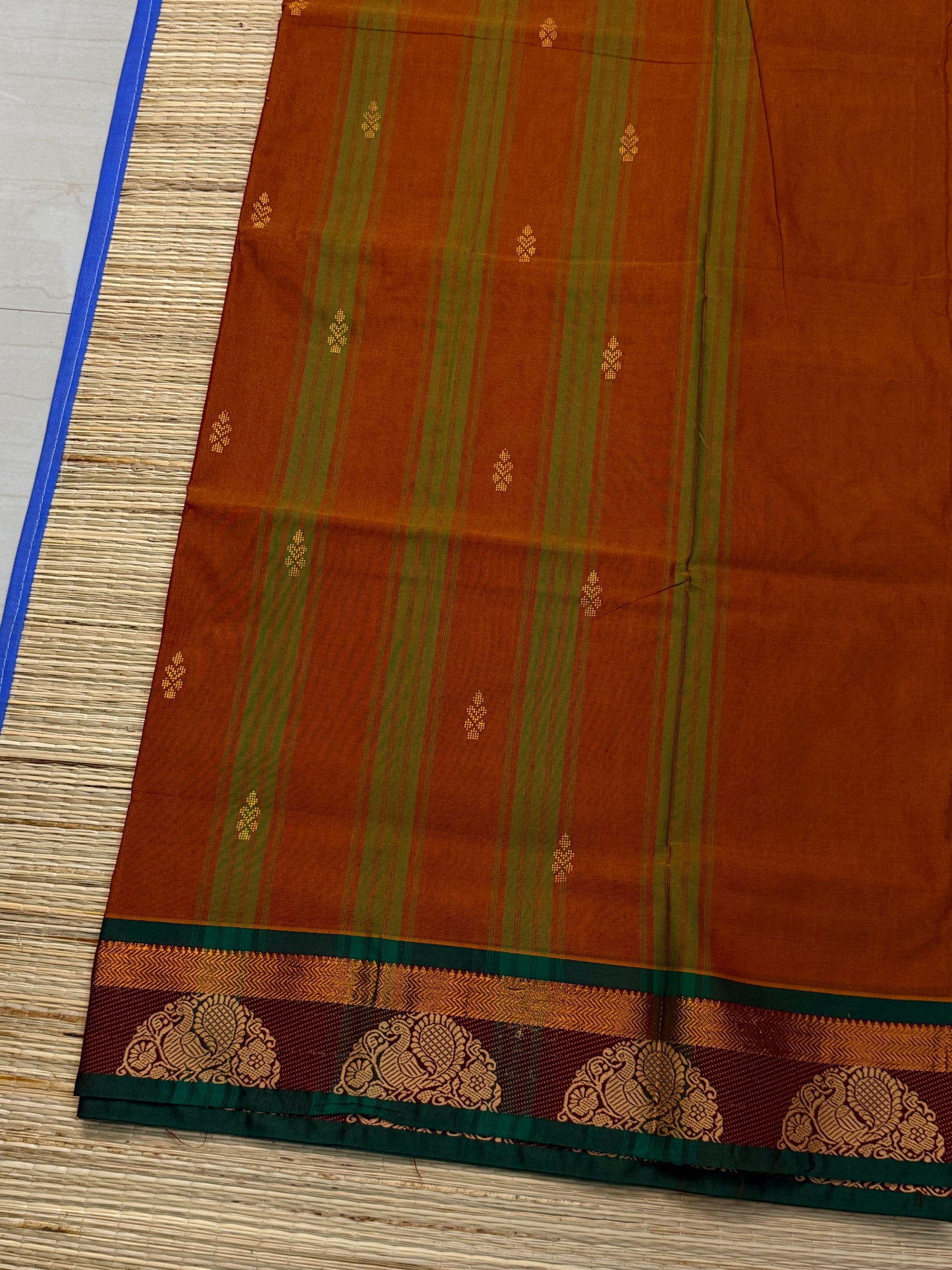 Rust Kanchi Cotton Saree with Gold Zari Buttas & Peacock Medallion Border