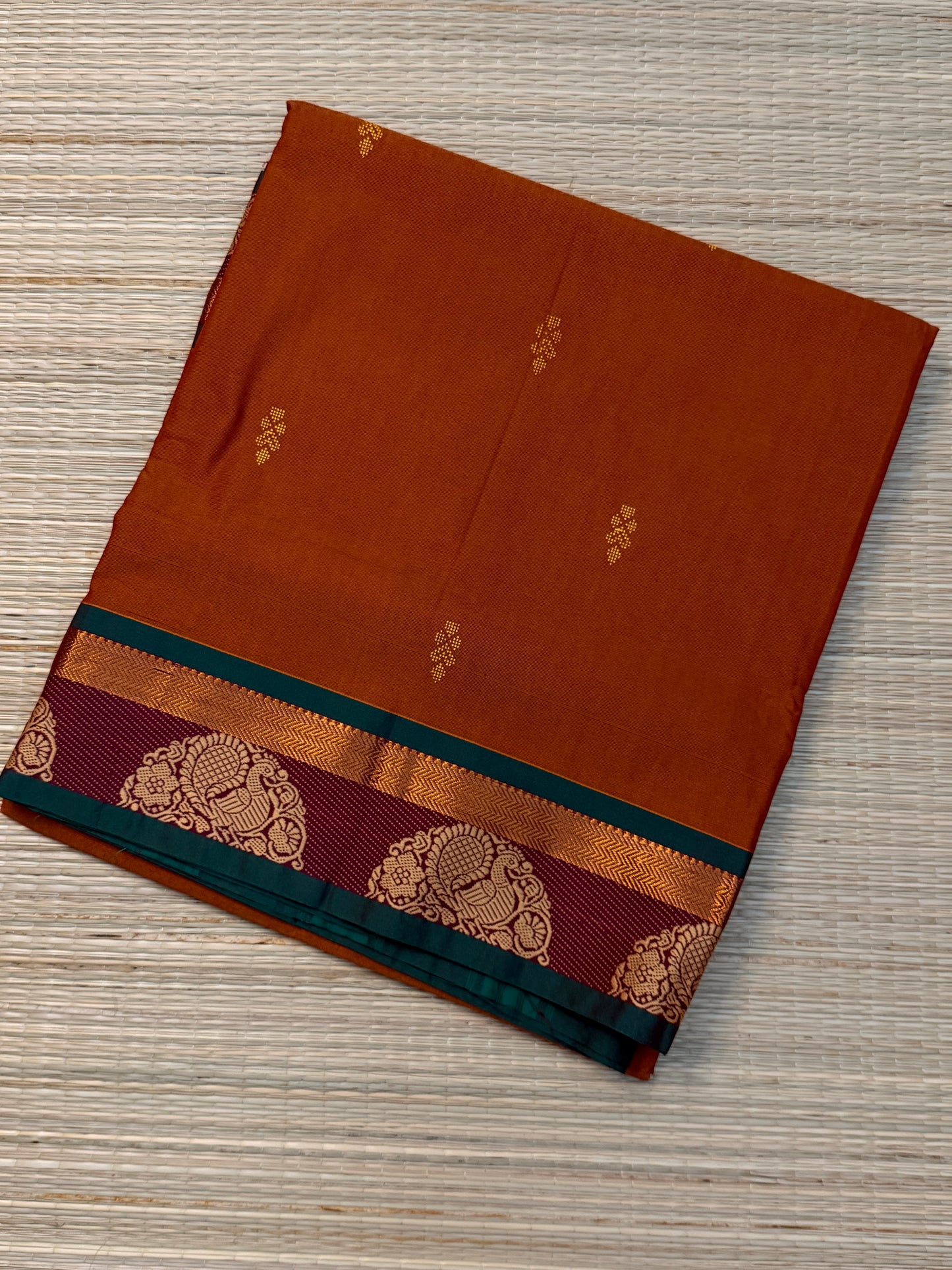 Rust Kanchi Cotton Saree with Gold Zari Buttas & Peacock Medallion Border
