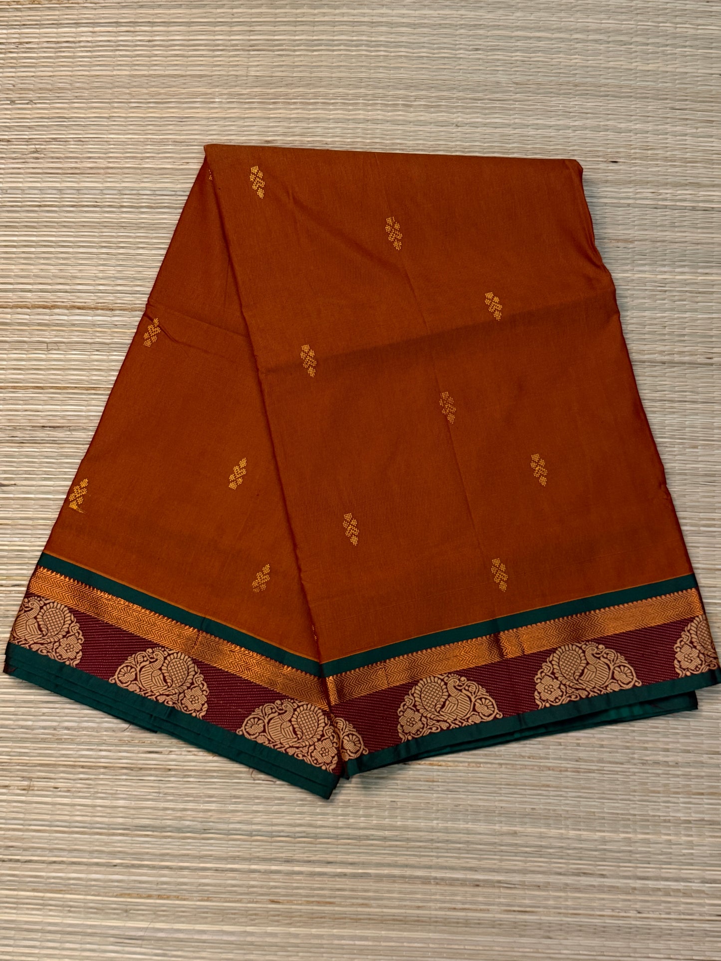 Rust Kanchi Cotton Saree with Gold Zari Buttas & Peacock Medallion Border